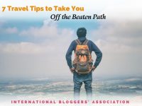 man standing on a bluff overlooking a city with text overlay "7 Travel Tips to Take You Off the Beaten Path"